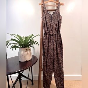 Anthropologie rust and navy jumpsuit with drawstring waist and beading.